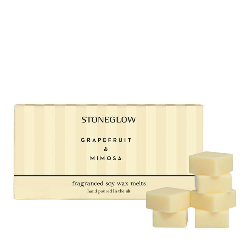 Experience the sweet, tangy scent of Grapefruit and Mimosa with these soy wax melts from Stoneglow Candles pictured with packaging and Melts