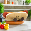 A soft toy hotdog sitting in the kitchen